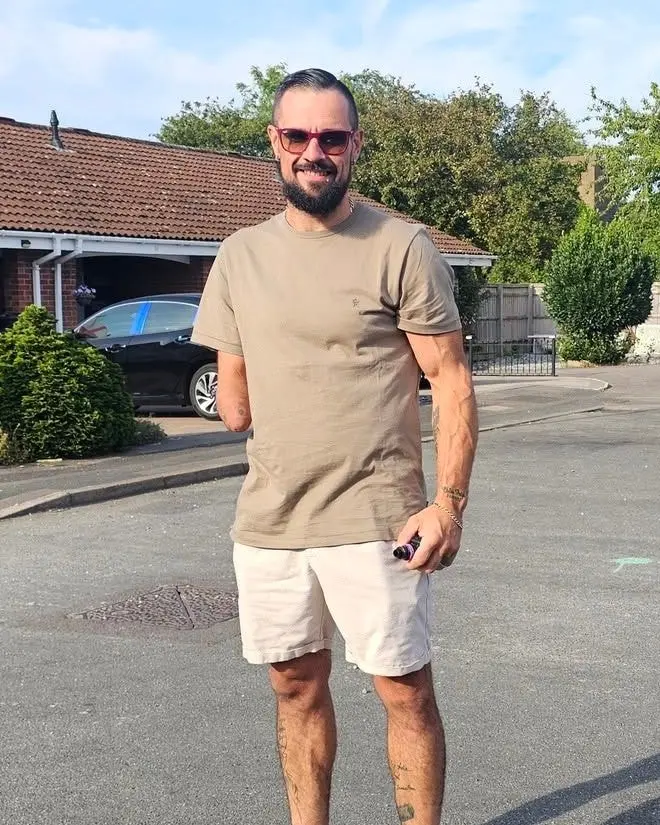 Nemo today, smiling in sunglasses, a khaki T-shirt and shorts